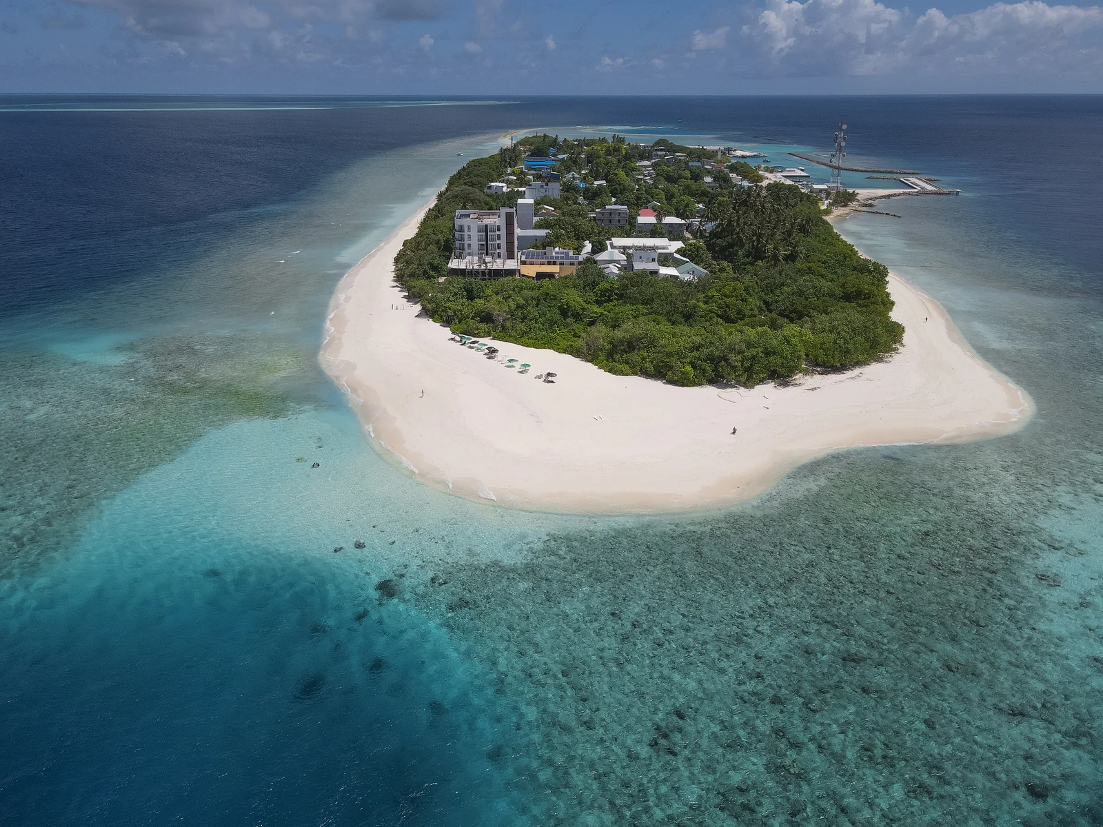 Aerial view of the green island of Ukulhas, its beach and reef