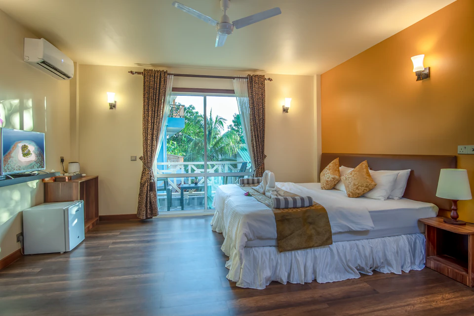 View of the double bed with the balcony doors directly behind it