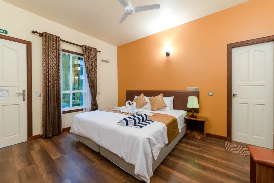 Double-bed room overview with window, desk, and entrance