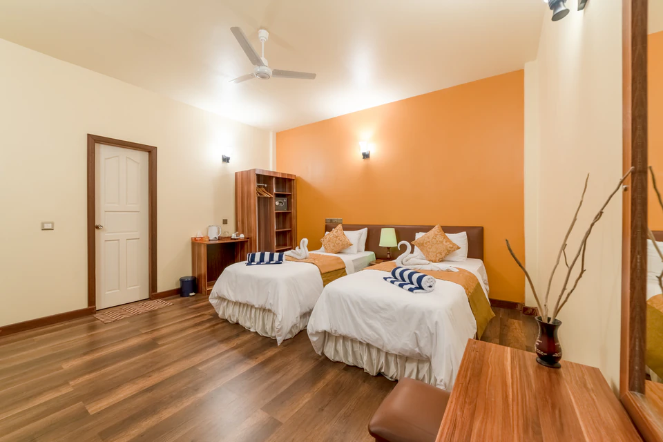 Angled view of twin beds and the room entrance