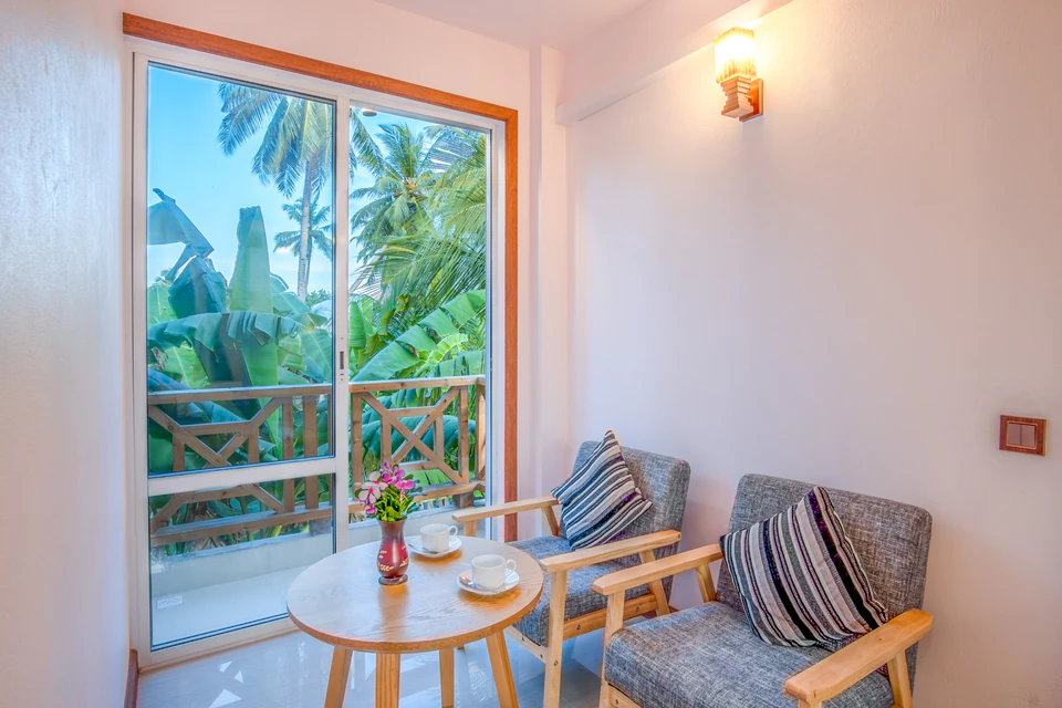 Balcony seating area with two chairs and a small table