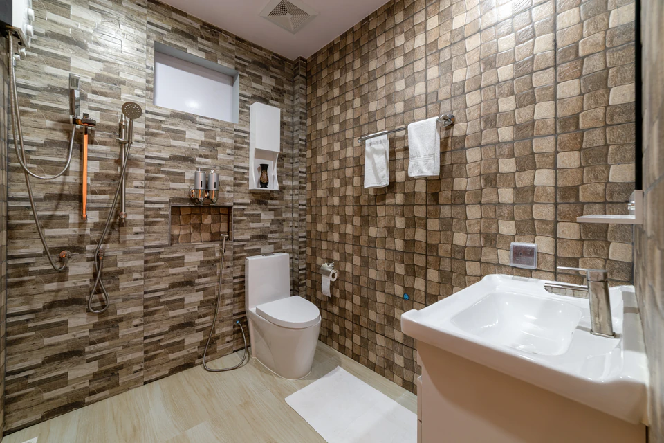 Tiled bathroom with shower, toilet, and vanity