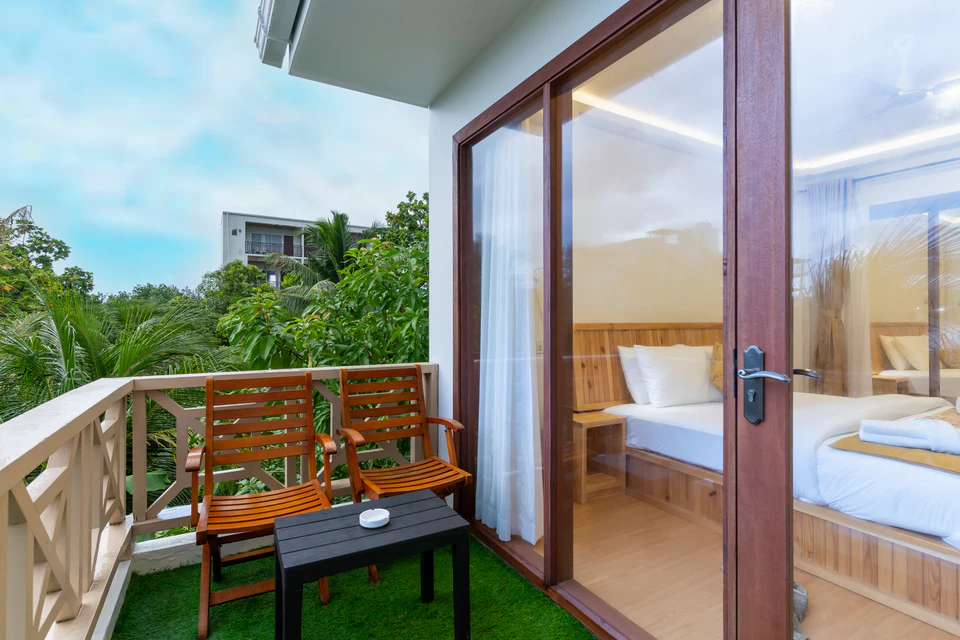 Private balcony seating viewed through the bedroom doors