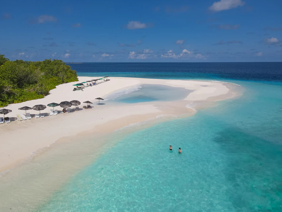 Aerial wide view of a white sandbank and turquoise lagoon